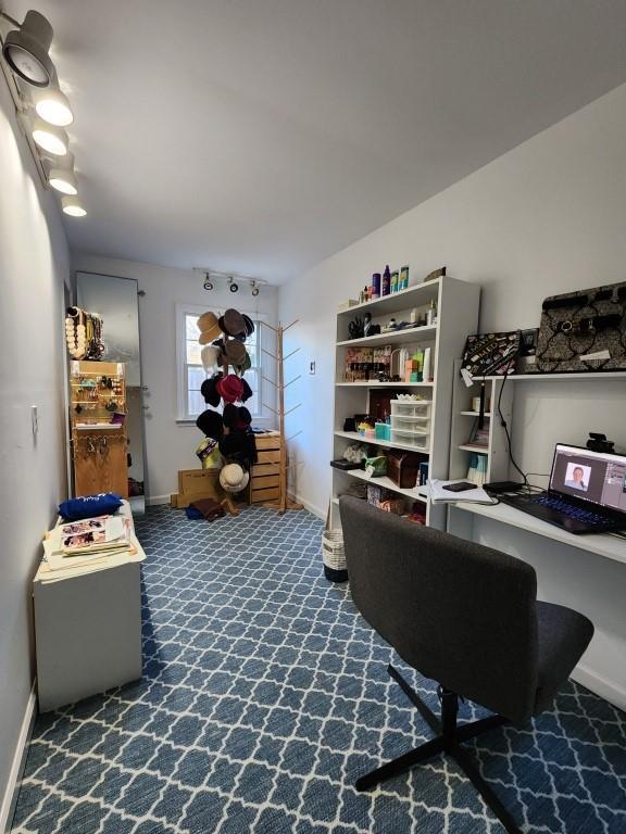carpeted office featuring baseboards