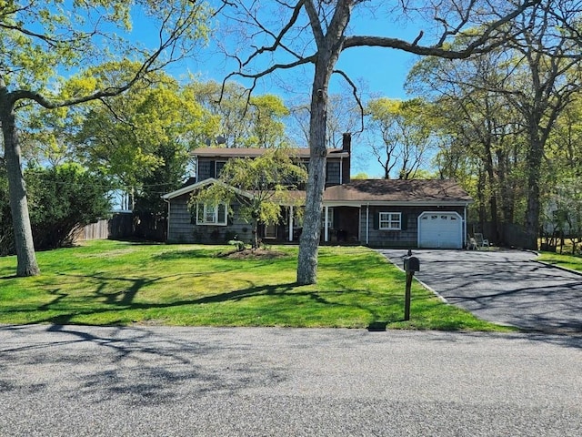 7 Mortimer St, Westhampton Beach, NY 11978 - view of front of property featuring a garage, asphalt driveway, and a chimney