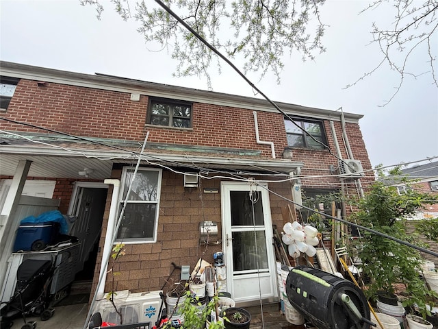 back of house with brick siding