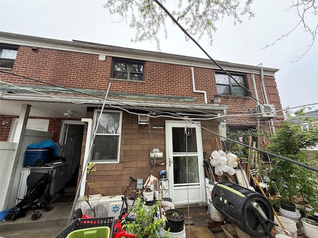 rear view of house with brick siding