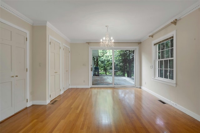 unfurnished dining area with baseboards, a wealth of natural light, a chandelier, and light wood-type flooring