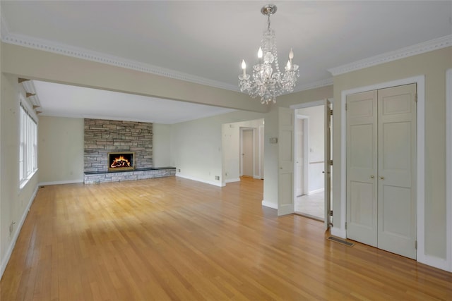 unfurnished living room featuring an inviting chandelier, light wood-type flooring, and visible vents