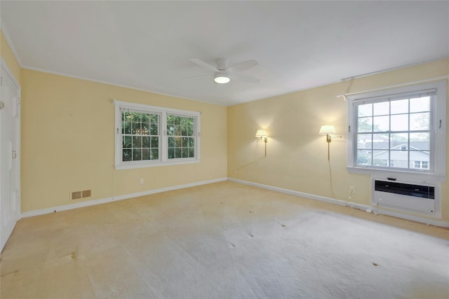unfurnished room featuring carpet flooring, visible vents, baseboards, and a ceiling fan