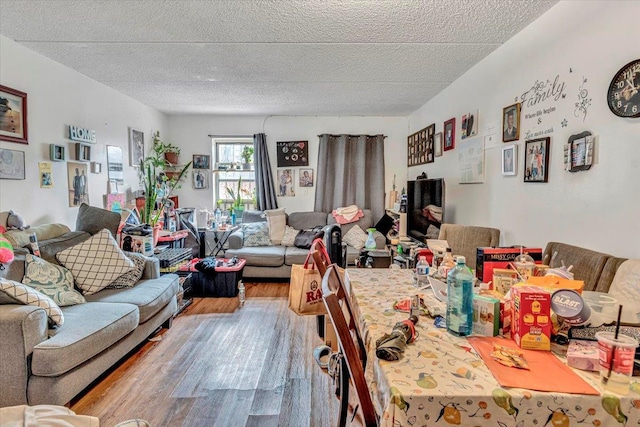 living room with a textured ceiling and wood finished floors