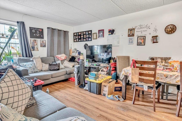 living area with a textured ceiling and wood finished floors