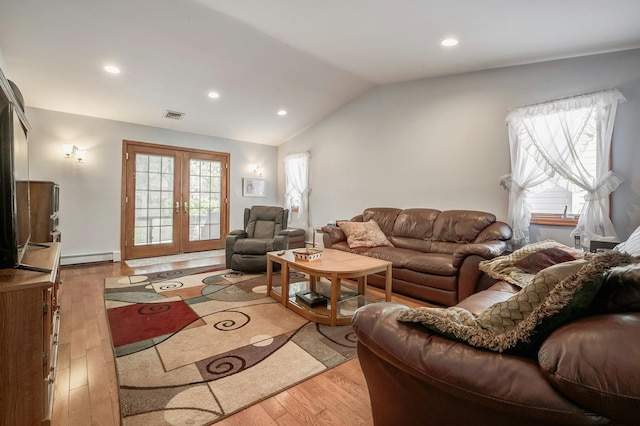 living area with lofted ceiling, wood-type flooring, french doors, and visible vents