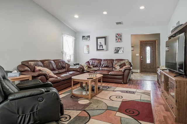living room featuring a wealth of natural light, visible vents, lofted ceiling, and recessed lighting
