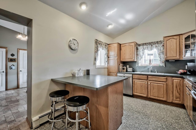 kitchen featuring a peninsula, a kitchen bar, a sink, stainless steel dishwasher, and vaulted ceiling