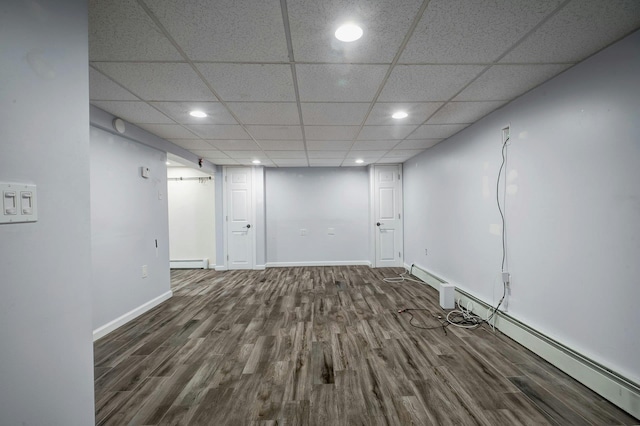 finished below grade area with a baseboard heating unit, baseboards, recessed lighting, and wood finished floors