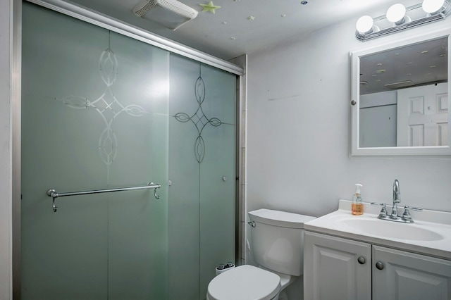 bathroom with a stall shower, vanity, toilet, and visible vents
