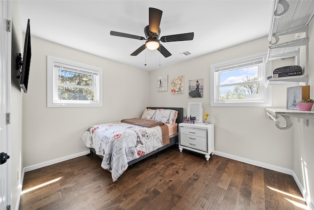 bedroom with dark wood-style flooring, baseboards, and visible vents