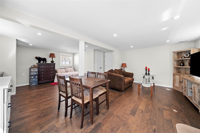 dining room featuring dark wood-type flooring, baseboards, visible vents, and recessed lighting