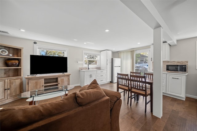 living area featuring baseboards, dark wood-style flooring, recessed lighting, and visible vents