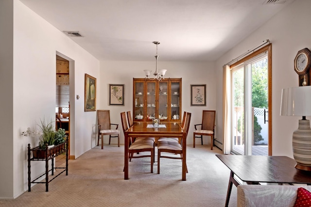 dining room featuring light colored carpet, an inviting chandelier, visible vents, and a baseboard radiator