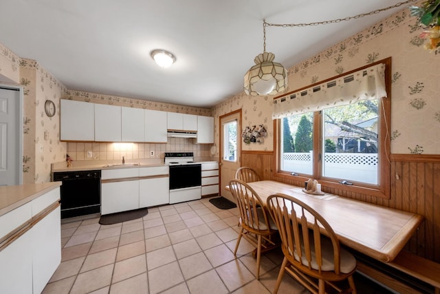 kitchen featuring light countertops, wallpapered walls, under cabinet range hood, dishwasher, and range with electric stovetop