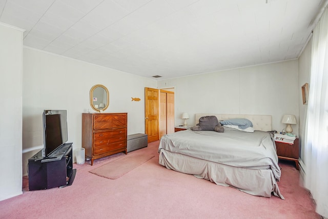 carpeted bedroom featuring visible vents and ornamental molding