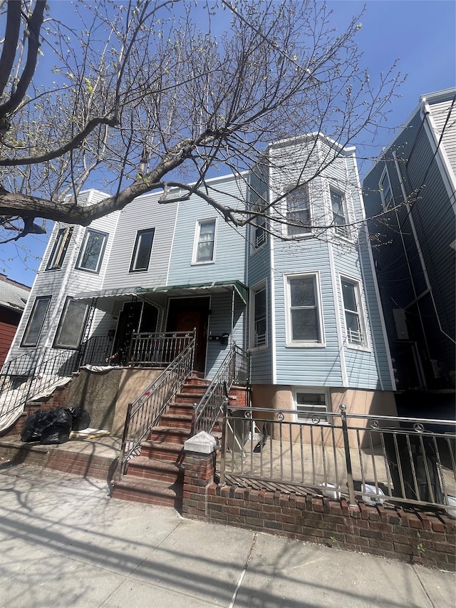 townhome / multi-family property with a porch