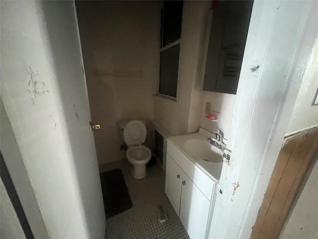 bathroom with vanity, toilet, and tile patterned floors