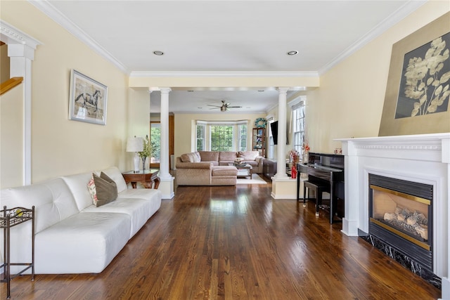 131 2nd St, Garden City, NY 11530 - living area featuring decorative columns, dark wood-type flooring, a glass covered fireplace, a ceiling fan, and crown molding