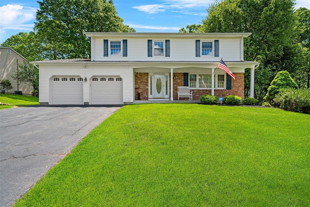 35 Capt Faldermeyer Dr, Stony Point, NY 10980 - traditional-style house featuring asphalt driveway, a front lawn, covered porch, and brick siding