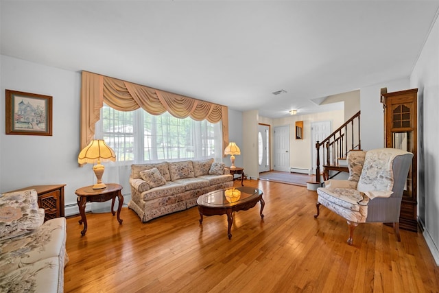 35 Capt Faldermeyer Dr, Stony Point, NY 10980 - living area with stairway, light wood finished floors, baseboard heating, and baseboards