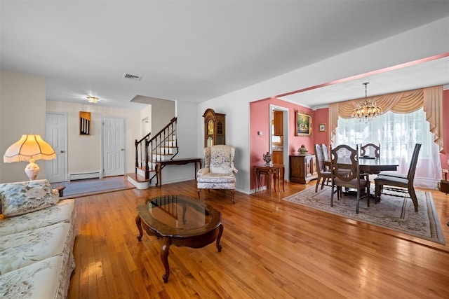 35 Capt Faldermeyer Dr, Stony Point, NY 10980 - living area featuring a baseboard radiator, light wood-style flooring, stairway, a chandelier, and baseboards