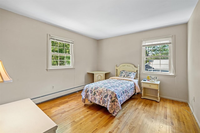 35 Capt Faldermeyer Dr, Stony Point, NY 10980 - bedroom featuring a baseboard heating unit, light wood-type flooring, and baseboards