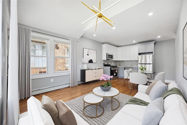 living room featuring light wood finished floors, baseboard heating, recessed lighting, and vaulted ceiling