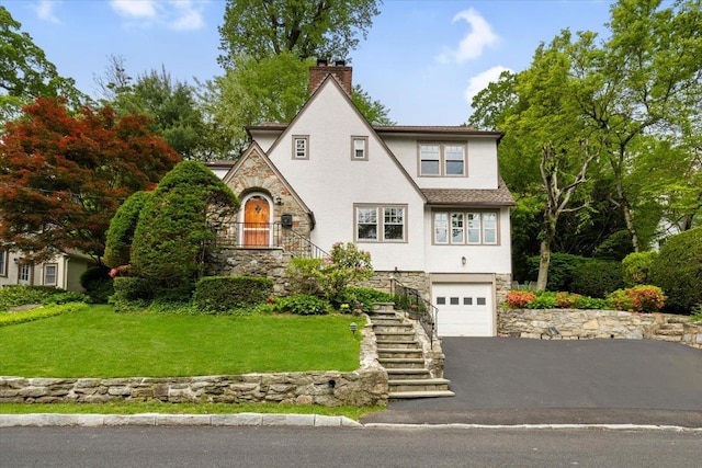 67 Walbrooke Rd, Scarsdale, NY 10583 - tudor-style house featuring stone siding, stucco siding, a chimney, a garage, and stairs