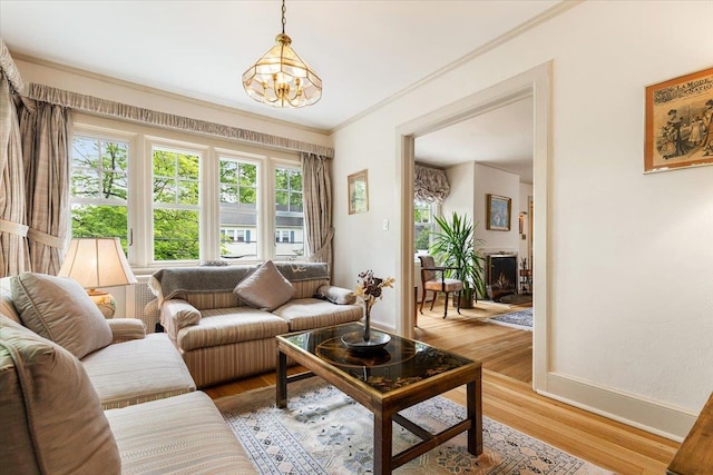 67 Walbrooke Rd, Scarsdale, NY 10583 - living area featuring a chandelier, crown molding, baseboards, and light wood-type flooring