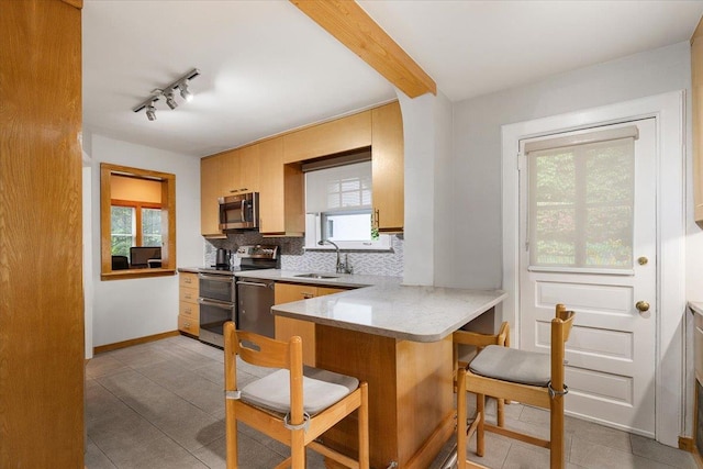 67 Walbrooke Rd, Scarsdale, NY 10583 - kitchen with stainless steel appliances, a sink, light tile patterned floors, backsplash, and a peninsula