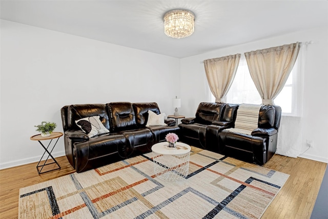 199 Guildford Ct, West Hempstead, NY 11552 - living room featuring a chandelier, wood finished floors, and baseboards