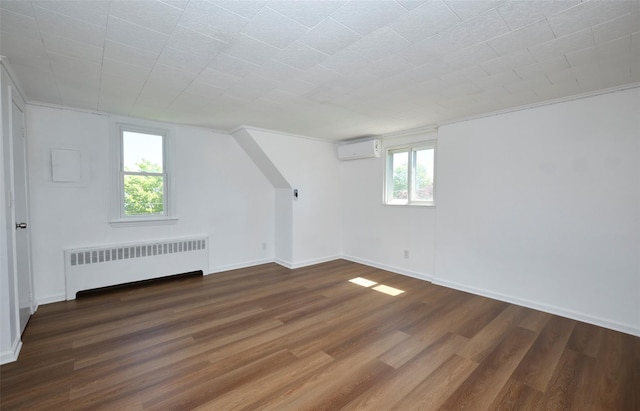 199 Guildford Ct, West Hempstead, NY 11552 - bonus room featuring radiator heating unit, an AC wall unit, wood finished floors, and baseboards