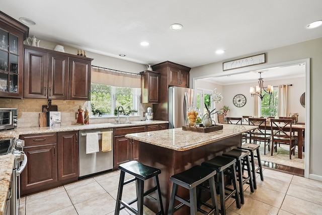 304 Church Rd, Putnam Valley, NY 10579 - kitchen with appliances with stainless steel finishes, a sink, light tile patterned floors, a kitchen breakfast bar, and recessed lighting