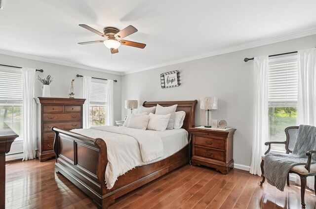 304 Church Rd, Putnam Valley, NY 10579 - bedroom with multiple windows, a baseboard heating unit, wood finished floors, and crown molding