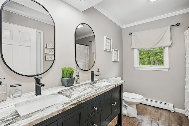 304 Church Rd, Putnam Valley, NY 10579 - full bath with a baseboard heating unit, toilet, wood finished floors, double vanity, and ornamental molding