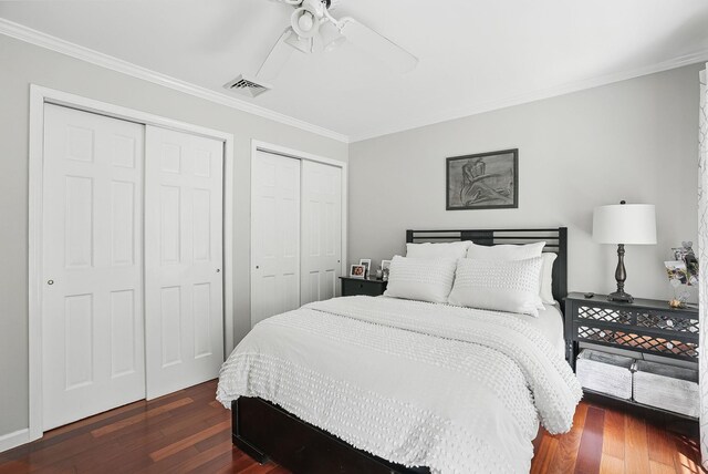 304 Church Rd, Putnam Valley, NY 10579 - bedroom featuring two closets, dark wood-style flooring, ornamental molding, and ceiling fan