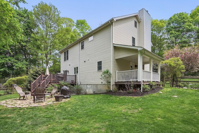 304 Church Rd, Putnam Valley, NY 10579 - rear view of property featuring a lawn, an outdoor fire pit, and a patio