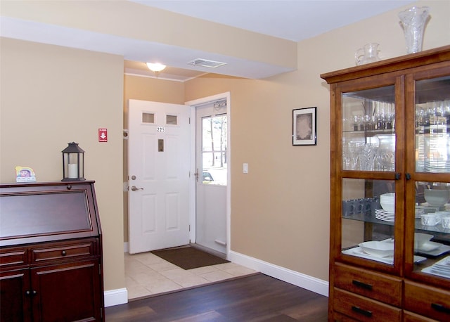 entrance foyer featuring baseboards, light wood-style flooring, and visible vents