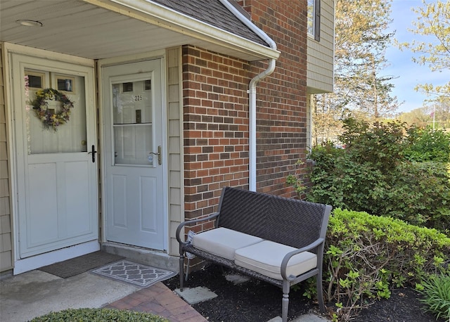 entrance to property featuring brick siding