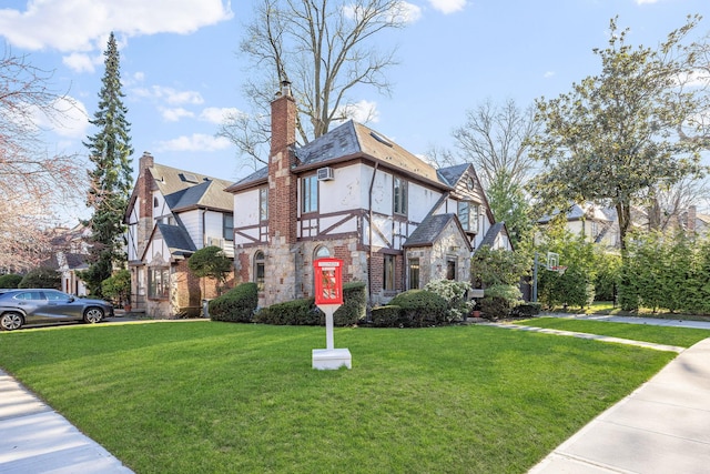 8702 Chevy Chase St, Jamaica Estates, NY 11432 - view of front of house featuring a front lawn, stucco siding, a chimney, stone siding, and a residential view