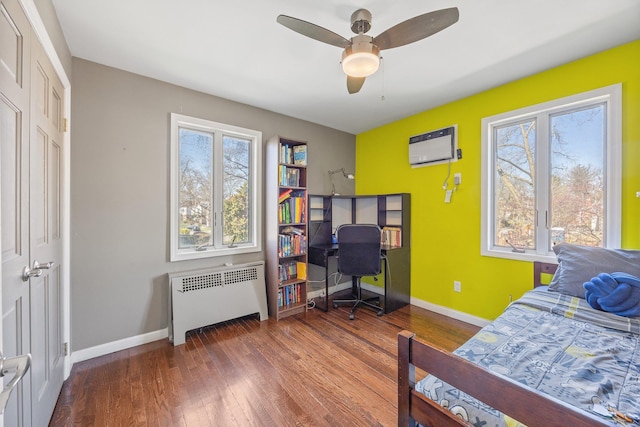 8702 Chevy Chase St, Jamaica Estates, NY 11432 - bedroom with radiator heating unit, multiple windows, and baseboards