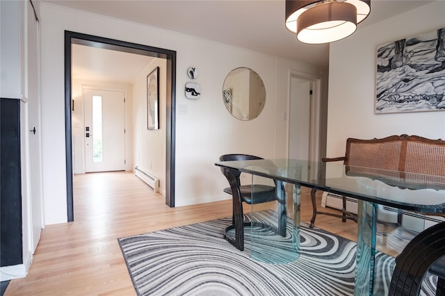 96 Grove St, Beacon, NY 12508 - dining area with a baseboard heating unit, light wood-style flooring, and crown molding