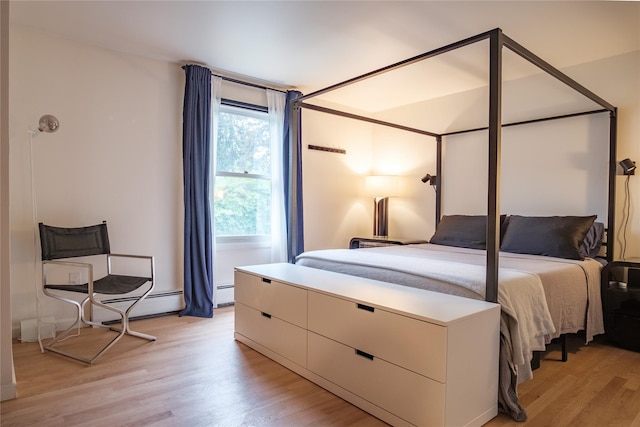 96 Grove St, Beacon, NY 12508 - bedroom featuring light wood-type flooring and a baseboard heating unit