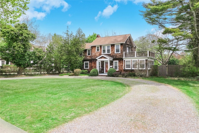 7 N Howells Point Rd, Bellport Village, NY 11713 - colonial-style house with a chimney, a balcony, curved driveway, and roof with shingles