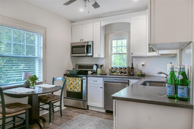 7 N Howells Point Rd, Bellport Village, NY 11713 - kitchen with appliances with stainless steel finishes, a sink, white cabinetry, ceiling fan, and recessed lighting