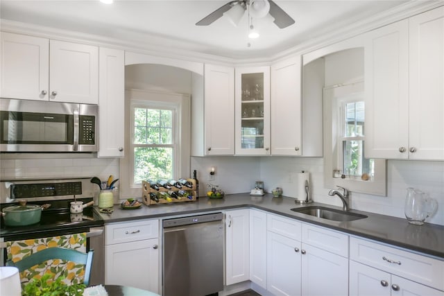 7 N Howells Point Rd, Bellport Village, NY 11713 - kitchen with appliances with stainless steel finishes, a sink, decorative backsplash, and dark countertops
