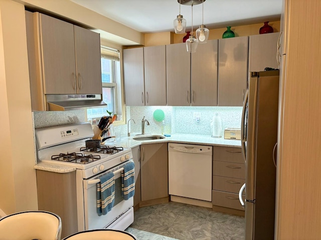 kitchen with under cabinet range hood, decorative light fixtures, white appliances, a sink, and backsplash