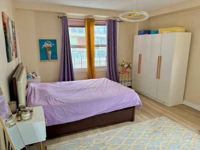 bedroom with baseboards and light wood-type flooring