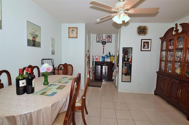 dining area with ceiling fan, baseboards, and light tile patterned floors